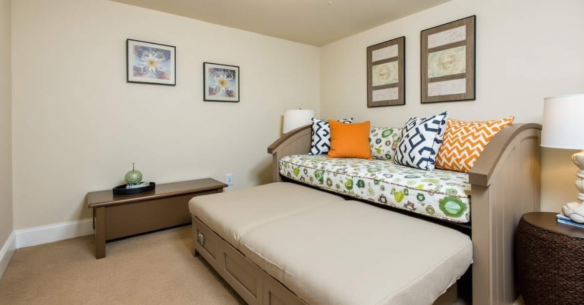Transform Your Basement:10 Basement Bedroom Ideas You’ll Love 6 Basement bedroom with a daybed and ottoman storage.